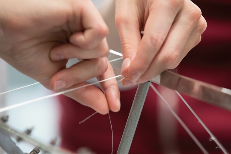 Hands holding threads